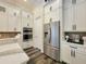 Kitchen featuring stainless steel appliances, white cabinets, and a modern design at 15707 Cutter Sail Pl, Winter Garden, FL 34787