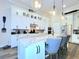 A well-lit kitchen showcases a spacious island with seating and pendant lighting at 15707 Cutter Sail Pl, Winter Garden, FL 34787