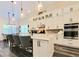 Modern kitchen with island seating, stainless steel appliances, and pendant lights at 15707 Cutter Sail Pl, Winter Garden, FL 34787