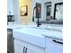 Bright kitchen features a farmhouse sink, neutral countertops, and modern fixtures at 15707 Cutter Sail Pl, Winter Garden, FL 34787