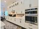Well-equipped kitchen with stainless steel appliances, white cabinetry, and stylish backsplash at 15707 Cutter Sail Pl, Winter Garden, FL 34787