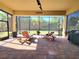 Relaxing screened lanai with lounge chairs, a ceiling fan, and views of the lush backyard at 15707 Cutter Sail Pl, Winter Garden, FL 34787