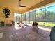 Spacious, shaded patio with a ceiling fan, outdoor furniture and a view of the landscaped backyard at 15707 Cutter Sail Pl, Winter Garden, FL 34787