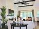Cozy living room with fireplace, comfortable seating, and access to the outdoor patio at 15707 Cutter Sail Pl, Winter Garden, FL 34787