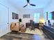 Inviting home office featuring a leather sofa, modern desk, and a large window with plantation shutters at 15707 Cutter Sail Pl, Winter Garden, FL 34787