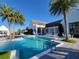 Beautiful community pool and clubhouse surrounded by palm trees and lounge chairs at 15707 Cutter Sail Pl, Winter Garden, FL 34787