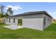 Exterior view highlighting the back yard and sliding glass door access at 15823 Sw 27Th Avenue Rd, Ocala, FL 34473