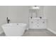 Bathroom with soaking tub, tiled floor and double sink vanity with modern fixtures at 15823 Sw 27Th Avenue Rd, Ocala, FL 34473