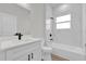 Modern bathroom featuring double sinks, black fixtures, and a tub/shower combination at 15823 Sw 27Th Avenue Rd, Ocala, FL 34473