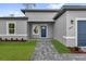 Charming home featuring a blue front door and a well-maintained brick walkway at 15823 Sw 27Th Avenue Rd, Ocala, FL 34473