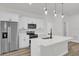 Modern kitchen features stainless steel appliances, white cabinets, and center island with sink at 15823 Sw 27Th Avenue Rd, Ocala, FL 34473