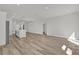 Expansive open-concept layout with wood-look floors, seamlessly connecting the living, dining, and kitchen areas at 15823 Sw 27Th Avenue Rd, Ocala, FL 34473