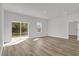 Spacious living room with wood-look floors, sliding glass doors to yard, and a view of the backyard at 15823 Sw 27Th Avenue Rd, Ocala, FL 34473