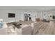 Bright open living room flows into the kitchen and dining area, furnished with modern furniture at 15823 Sw 27Th Avenue Rd, Ocala, FL 34473