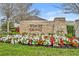 Stone community entrance sign for Wincey Groves at Hamlin, with colorful flower bed in front and blue skies at 16238 Misty Hills Ave, Winter Garden, FL 34787