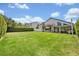 Expansive backyard with lush green lawn and covered patio at 1661 Woodland Ave, Winter Park, FL 32789
