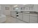 Bright bathroom featuring granite countertops, double vanities, tile floors, and neutral walls at 1661 Woodland Ave, Winter Park, FL 32789