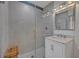 Modern bathroom with a glass-enclosed shower, stylish vanity, and neutral tile at 1661 Woodland Ave, Winter Park, FL 32789