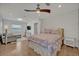 Cozy bedroom featuring hardwood floors, a ceiling fan, and a comfortable seating area at 1661 Woodland Ave, Winter Park, FL 32789