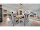 Open-concept dining room with rustic table, chandelier, and views to kitchen, living spaces, and stairway at 1661 Woodland Ave, Winter Park, FL 32789
