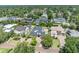 Beautifully landscaped property featuring a well-manicured lawn, mature trees, and elegant exterior design at 1661 Woodland Ave, Winter Park, FL 32789