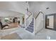 Elegant foyer with marble floors, staircase with white railings, and a view of the living and dining areas at 1661 Woodland Ave, Winter Park, FL 32789