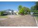 Beautiful home exterior with a circular driveway and lots of trees at 1661 Woodland Ave, Winter Park, FL 32789