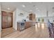 Open-concept bar area with custom cabinetry, wine cooler, and adjacent dining and living space at 1661 Woodland Ave, Winter Park, FL 32789
