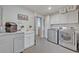 Well-equipped laundry room with modern washer, dryer, ample storage, and convenient sink at 1661 Woodland Ave, Winter Park, FL 32789