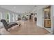 Bright living room with wood floors, arched windows, and a chaise lounge, flowing into the dining and kitchen areas at 1661 Woodland Ave, Winter Park, FL 32789