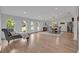 Spacious living area with hardwood floors, arched windows, a chaise lounge, and a dining table at 1661 Woodland Ave, Winter Park, FL 32789