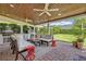 Cozy outdoor space with comfortable seating, a pizza oven, grill, and a wood ceiling at 1661 Woodland Ave, Winter Park, FL 32789