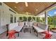Inviting covered patio features comfortable seating and an outdoor kitchen with a pizza oven at 1661 Woodland Ave, Winter Park, FL 32789