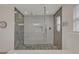Modern shower with glass enclosure, rain showerhead, and sleek tile work at 1661 Woodland Ave, Winter Park, FL 32789