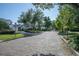 Scenic street view with beautiful homes, mature trees, and neat landscaping at 1661 Woodland Ave, Winter Park, FL 32789