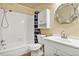 Bathroom with a shower-tub combo, updated sink and vanity, and a mirror at 1728 Townhall Ln # 1728, Orlando, FL 32807