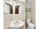 Cozy half bath with white sink, toilet and chrome hardware at 1728 Townhall Ln # 1728, Orlando, FL 32807