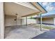 A spacious carport with a concrete drive and view of the side entrance at 1728 Townhall Ln # 1728, Orlando, FL 32807