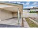 A spacious carport with a concrete drive and view of the home's exterior at 1728 Townhall Ln # 1728, Orlando, FL 32807
