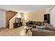 Inviting living room with tile floors, a comfortable sofa, and a staircase to upper level at 1728 Townhall Ln # 1728, Orlando, FL 32807