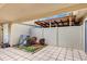Tiled patio featuring a garden with a newer AC unit, offering a private outdoor space at 1728 Townhall Ln # 1728, Orlando, FL 32807