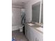 Bright bathroom with a double sink vanity, tiled floors, and a shower/tub combo at 17333 Cagan Crossings Blvd, Clermont, FL 34714