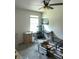 Bedroom featuring a ceiling fan, large window, and various furniture pieces and a carpeted floor at 17333 Cagan Crossings Blvd, Clermont, FL 34714