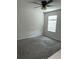 Cozy bedroom with a ceiling fan and plush carpet, bathed in natural light from a window at 17333 Cagan Crossings Blvd, Clermont, FL 34714
