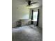 Bedroom with carpeted floor, a ceiling fan, a window, and a dresser with a small table at 17333 Cagan Crossings Blvd, Clermont, FL 34714
