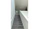 View of the carpeted stairs in the home, leading to the upper level, with white risers and railing at 17333 Cagan Crossings Blvd, Clermont, FL 34714