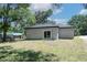 Exterior of home featuring a backyard with sliding glass doors at 1819 Carr St, Deland, FL 32720