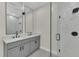 Spacious bathroom featuring double sinks, modern lighting, and a glass-enclosed shower at 1819 Carr St, Deland, FL 32720