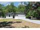 Charming single-story home featuring a two-car garage, fresh landscaping, and a well-manicured lawn at 1819 Carr St, Deland, FL 32720