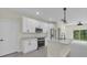Bright, open kitchen with white cabinets, stainless steel appliances, and island at 1819 Carr St, Deland, FL 32720